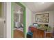 Hallway with wood floors leading to a bathroom, featuring colorful trim and a view of the space at 2409 Hodges Rd, Burlington, NC 27217