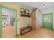 Charming hallway with unique brick detail, rustic storage, and a glimpse into the kitchen at 2409 Hodges Rd, Burlington, NC 27217