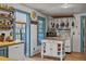 Quaint kitchen featuring a vintage stove, butcher block island, and blue-trimmed windows for a touch of charm at 2409 Hodges Rd, Burlington, NC 27217