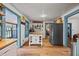 Well-lit kitchen showcasing a butcher block island, stainless steel refrigerator, and wood-style floors at 2409 Hodges Rd, Burlington, NC 27217