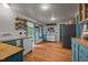 Cozy kitchen boasting wooden floors, beadboard walls, and blue painted cabinets with butcher block countertops at 2409 Hodges Rd, Burlington, NC 27217
