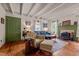 Comfortable living room features a fireplace, wood floors, beamed ceilings, and stylish decor at 2409 Hodges Rd, Burlington, NC 27217