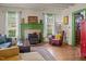 Well-lit living room with hardwood floors, wood burning stove, and lots of windows at 2409 Hodges Rd, Burlington, NC 27217