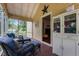 Screened porch showcasing wicker furniture and vintage cabinet, perfect for relaxing at 2409 Hodges Rd, Burlington, NC 27217