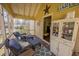 Relaxing screened-in porch with comfortable wicker furniture and view, creating a cozy outdoor space at 2409 Hodges Rd, Burlington, NC 27217