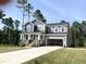 Well-manicured two-story home boasts stone accents, a covered porch, and a spacious two-car garage at 266 Golfview Ave, Benson, NC 27504