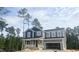 Two-story home with gray siding and a covered porch, awaiting its final touches at 266 Golfview Ave, Benson, NC 27504