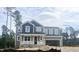 Two-story home with gray siding and a covered porch, awaiting its final touches at 266 Golfview Ave, Benson, NC 27504