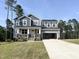 Beautiful two-story home with stone accents, a covered porch, and an attached two-car garage at 266 Golfview Ave, Benson, NC 27504