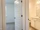 A doorway highlights a vanity with white cabinetry leading to a bedroom at 283 Golfview Avenue, Benson, NC 27504