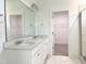 Bright bathroom features a double vanity, large mirror, and access to a walk-in closet at 283 Golfview Avenue, Benson, NC 27504