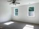 Bright bedroom features neutral carpeting, two windows, and white walls at 283 Golfview Avenue, Benson, NC 27504