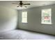 Bedroom with natural light through windows, complemented by a ceiling fan for comfort at 283 Golfview Avenue, Benson, NC 27504