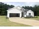 New construction exterior with a two-car garage, stone accents, and manicured lawn at 283 Golfview Avenue, Benson, NC 27504