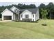 Exterior showcasing a new construction home with manicured lawn and tree at 283 Golfview Avenue, Benson, NC 27504