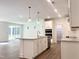 Modern kitchen featuring a central island, granite countertops, stainless steel appliances, and recessed lighting at 283 Golfview Avenue, Benson, NC 27504