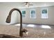 Close up of a granite island countertop in a kitchen with modern fixtures and natural lighting at 283 Golfview Avenue, Benson, NC 27504