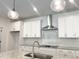 This modern kitchen boasts granite countertops and a stainless steel range hood at 283 Golfview Avenue, Benson, NC 27504