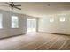 Bright living room features a sliding glass door and multiple windows at 283 Golfview Avenue, Benson, NC 27504