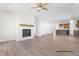 Living room featuring a fireplace with a mantle and an open floor plan with the kitchen in view at 346 Bluejay St, Clayton, NC 27520