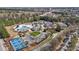 A community pool and tennis courts are surrounded by lush greenery in this attractive aerial shot at 3509 Archdale Dr, Raleigh, NC 27614