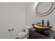 Stylish half bathroom with decorative sink, faucet and a decorative mirror at 3509 Archdale Dr, Raleigh, NC 27614
