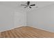 Spacious bedroom with wood flooring, a ceiling fan, and a double-door closet at 3509 Archdale Dr, Raleigh, NC 27614