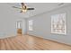 Bedroom with hardwood floors, two windows and ceiling fan at 3509 Archdale Dr, Raleigh, NC 27614