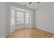 Bedroom featuring wood floors, a ceiling fan, and a bright bay window at 3509 Archdale Dr, Raleigh, NC 27614