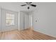 Bedroom featuring wood floors, ceiling fan, and a window for ample natural light at 3509 Archdale Dr, Raleigh, NC 27614