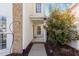 Home entrance featuring sidelight windows and a landscaped walkway at 3509 Archdale Dr, Raleigh, NC 27614
