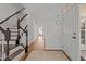 Bright foyer with hardwood floors, staircase, and modern lighting at 3509 Archdale Dr, Raleigh, NC 27614