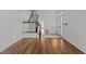 View of the bright foyer featuring hardwood floors, a staircase, and fresh paint at 3509 Archdale Dr, Raleigh, NC 27614