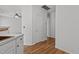 Hallway with hardwood floors and white doors at 3509 Archdale Dr, Raleigh, NC 27614