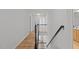 Hallway with hardwood floors, railing and two doors at 3509 Archdale Dr, Raleigh, NC 27614
