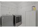 A laundry room with a modern washer and dryer and ample storage space at 3509 Archdale Dr, Raleigh, NC 27614