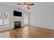 Cozy living room featuring hardwood floors, a fireplace, and lots of natural light at 3509 Archdale Dr, Raleigh, NC 27614