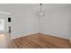 Bright living room featuring hardwood floors, fresh paint, and modern lighting at 3509 Archdale Dr, Raleigh, NC 27614