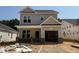 New construction, featuring a two-story home with an attached one-car garage and brick-accented entryway at 354 Bluejay St, Clayton, NC 27520