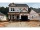 New construction home featuring brick accents and a two-car garage ready for customization at 354 Bluejay St, Clayton, NC 27520