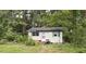 Cozy cottage-style home featuring a quaint front entrance and surrounded by mature trees at 3541 Holden Acres Dr, Wendell, NC 27591