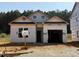 New construction home featuring an attached two-car garage with a front yard and green space in a quiet neighborhood at 362 Bluejay St, Clayton, NC 27520