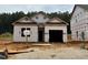 New construction home featuring an attached garage and covered entry, surrounded by a partially landscaped yard at 362 Bluejay St, Clayton, NC 27520
