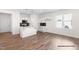 Kitchen view showing an island with sink, white cabinets, and stainless steel appliances at 362 Bluejay St, Clayton, NC 27520