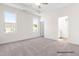 Carpeted main bedroom with large windows and a tray ceiling and ensuite bathroom at 362 Bluejay St, Clayton, NC 27520