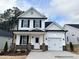 Charming two-story home with white siding, black shutters, and a welcoming front porch at 370 Bluejay St, Clayton, NC 27520