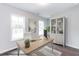 Well-lit home office with a spacious desk, a stylish bookcase, and large windows at 370 Bluejay St, Clayton, NC 27520
