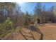 Backyard showcasing a wooden swing set and soccer goal, ideal for playtime and outdoor sports at 3708 Tansley St, Wake Forest, NC 27587