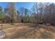 Open backyard with mature trees and a soccer net at 3708 Tansley St, Wake Forest, NC 27587