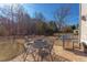Spacious backyard featuring a patio with a grill, dining set, and a fire pit at 3708 Tansley St, Wake Forest, NC 27587